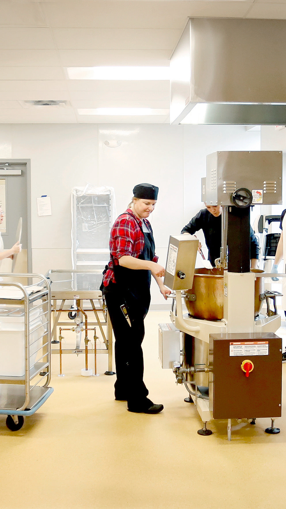 Chef operating industrial kitchen equipment.