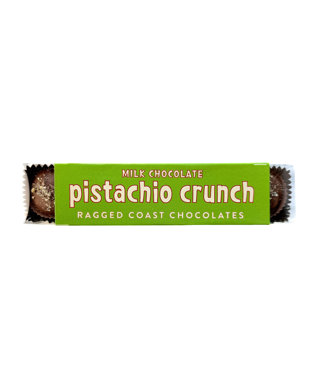 A green package labeled Milk Chocolate Pistachio Crunch Cups by Ragged Coast Chocolates, featuring direct-trade chocolate and handmade confections, with chocolate pieces partially visible at both ends.