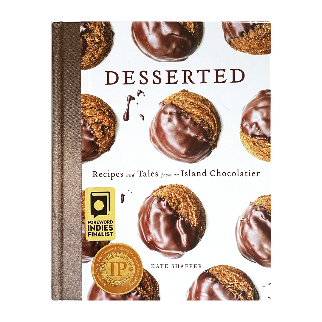 A cookbook titled "desserted: recipes and tales from an island chocolatier" by kate shaffer, featuring chocolate desserts on the cover.