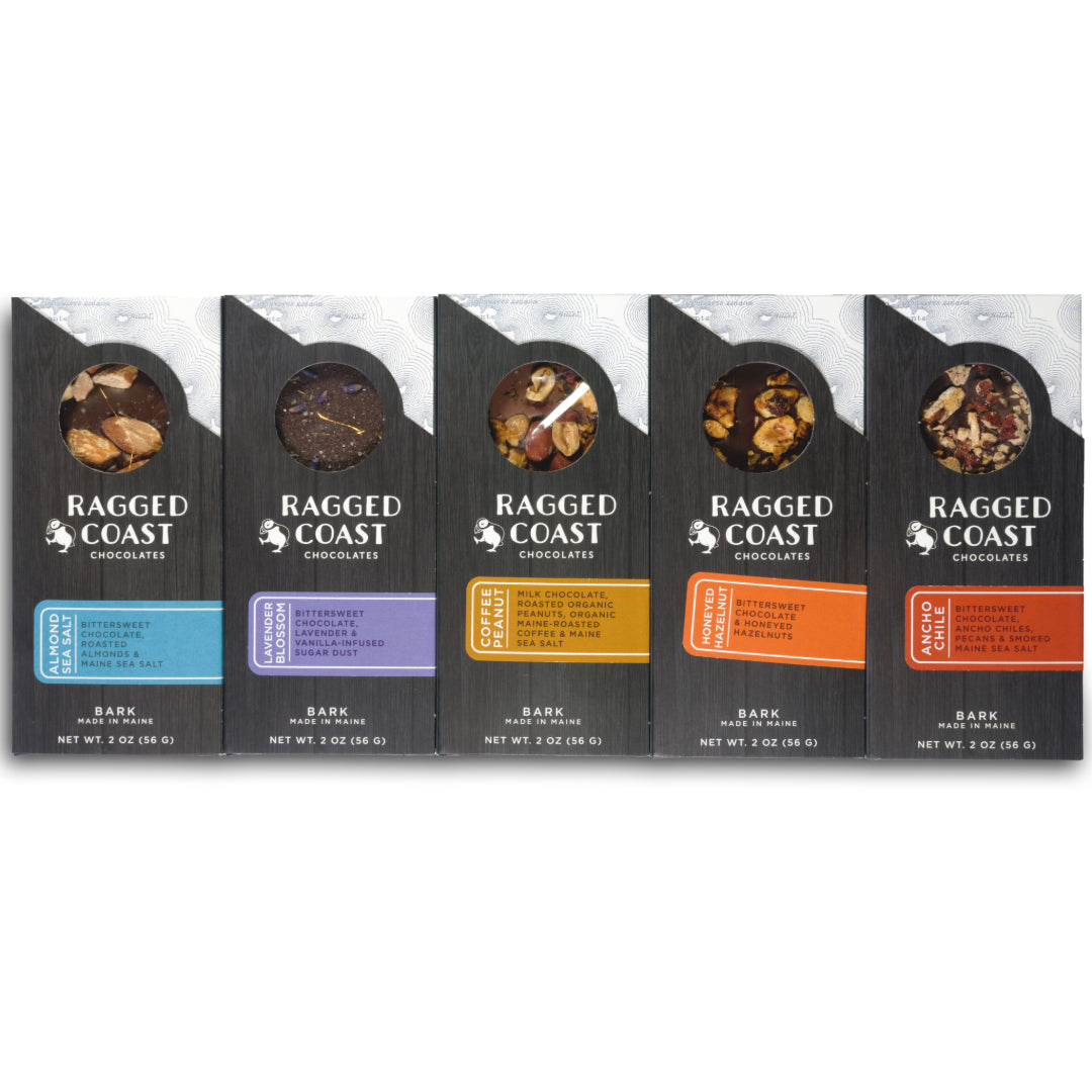 A set of five Ragged Coast Chocolates Chocolate Bark Bundle: Holiday Edition packages, each with different flavors including Maine sea salt, aligned next to each other.