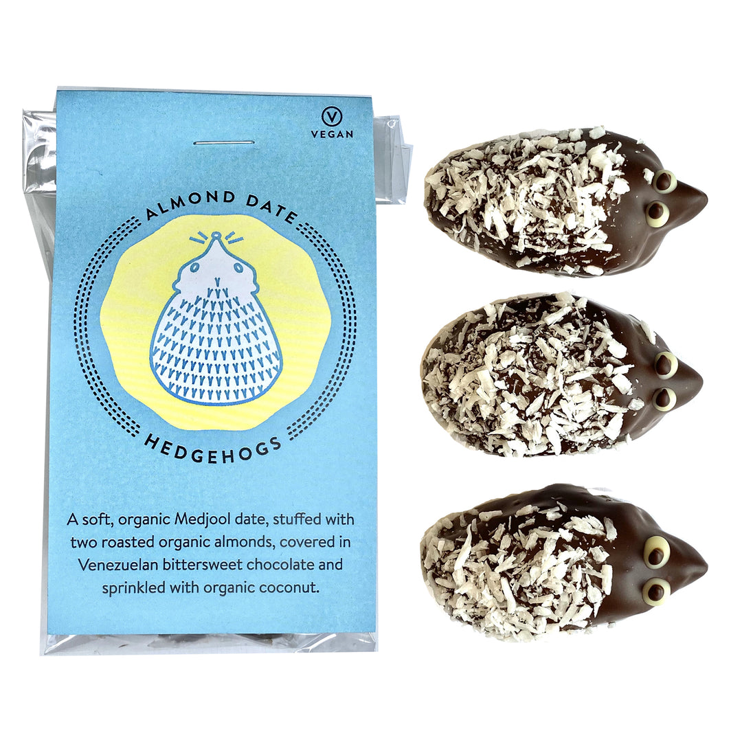 Two almond date hedgehog-shaped treats with coconut flakes next to their packaging, highlighting vegan and organic ingredients, perfect for Mother's Day chocolates from Ragged Coast Chocolates' The Gardener Bundles.