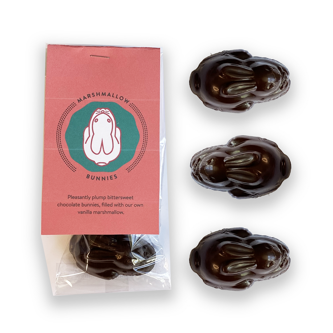 The Easter Gift Box by Ragged Coast Chocolates features three marshmallow-filled chocolate bunnies with the label "Marshmallow Bunnies," made of bittersweet single-origin chocolate and vanilla marshmallow, perfect for gifting.
