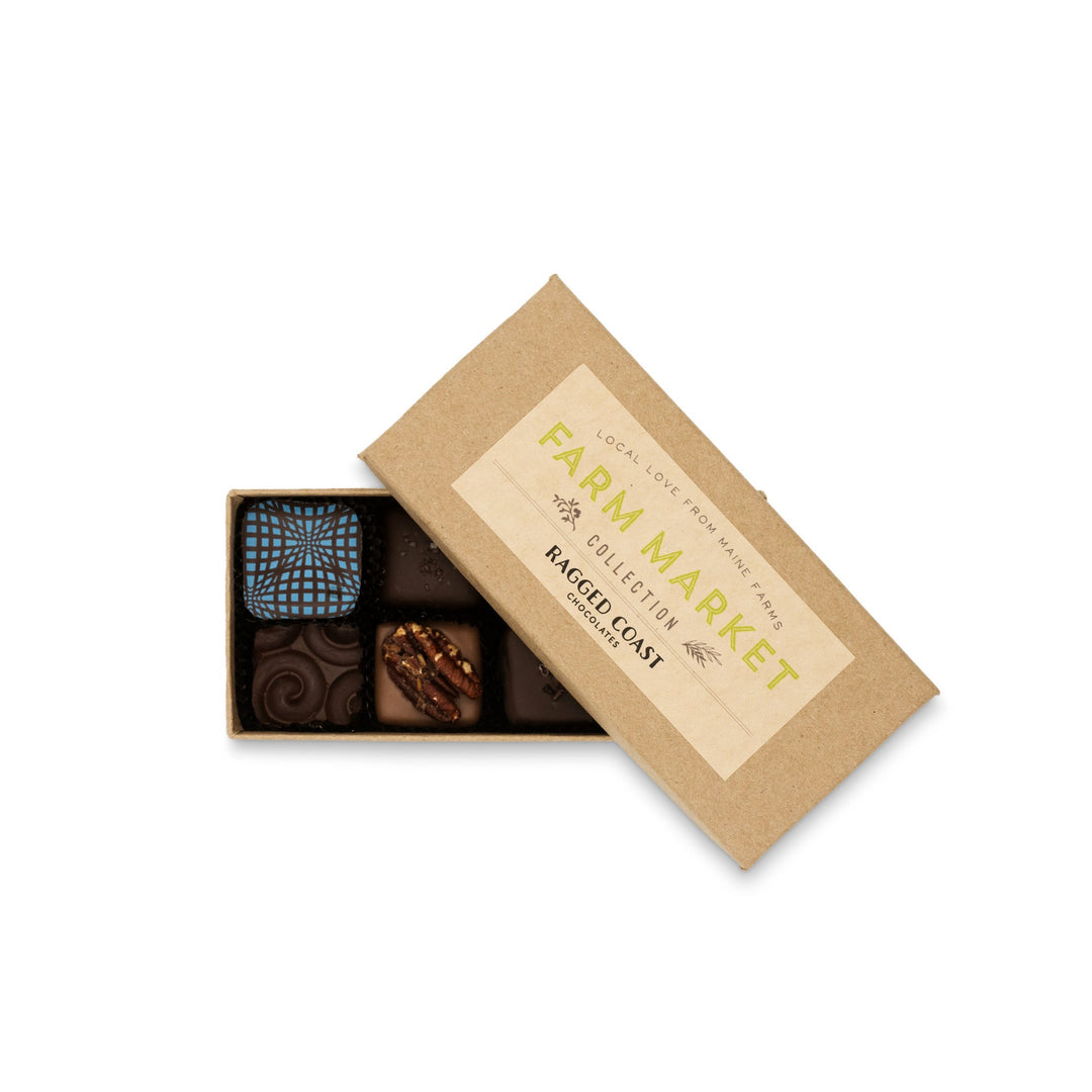 Box of Maine Farm Market Truffle Collection with a paper sleeve labeled "Ragged Coast Chocolates artisan chocolate collection" on a white background.