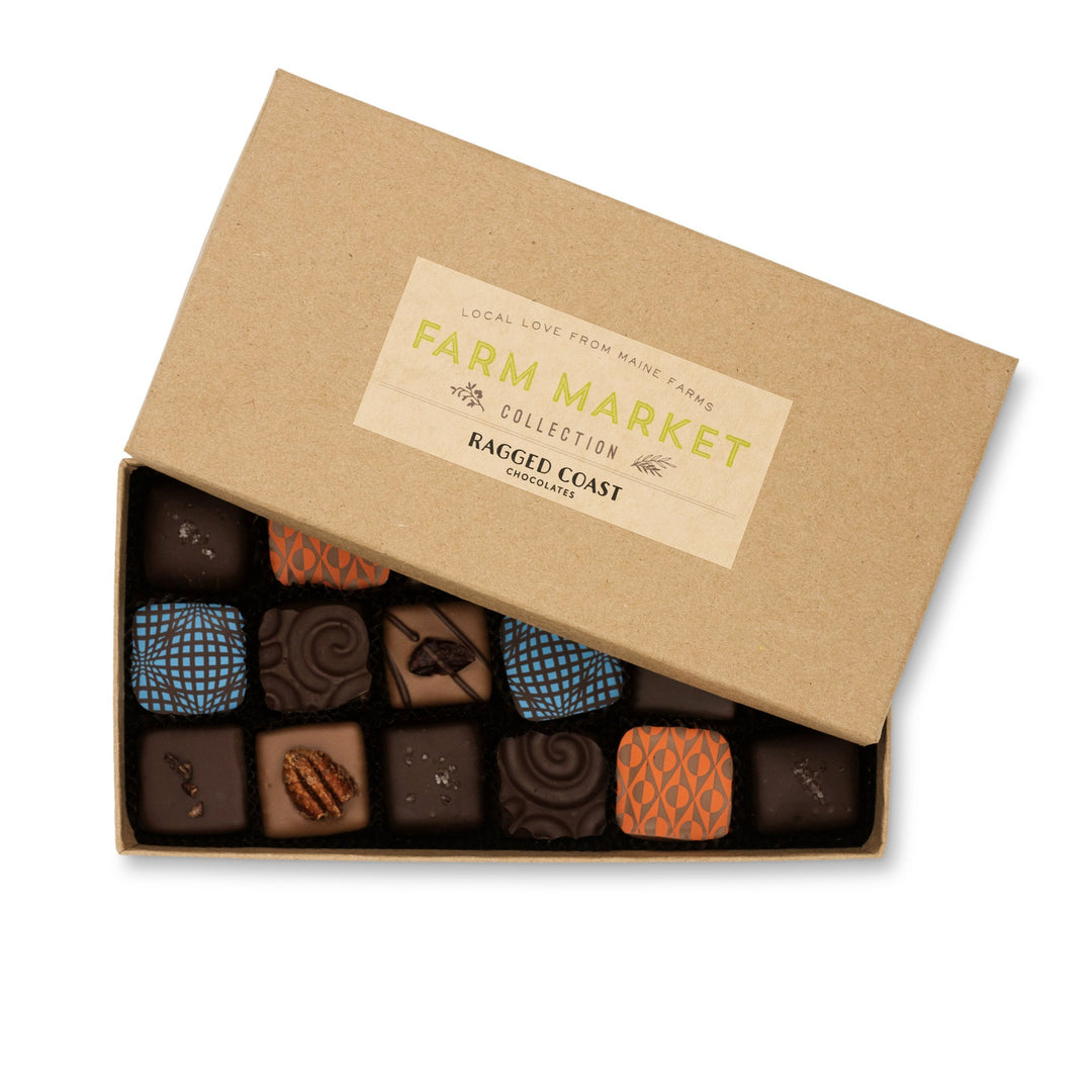 A box of Ragged Coast Chocolates Maine Farm Market Truffle Collection with unique designs on a white background.