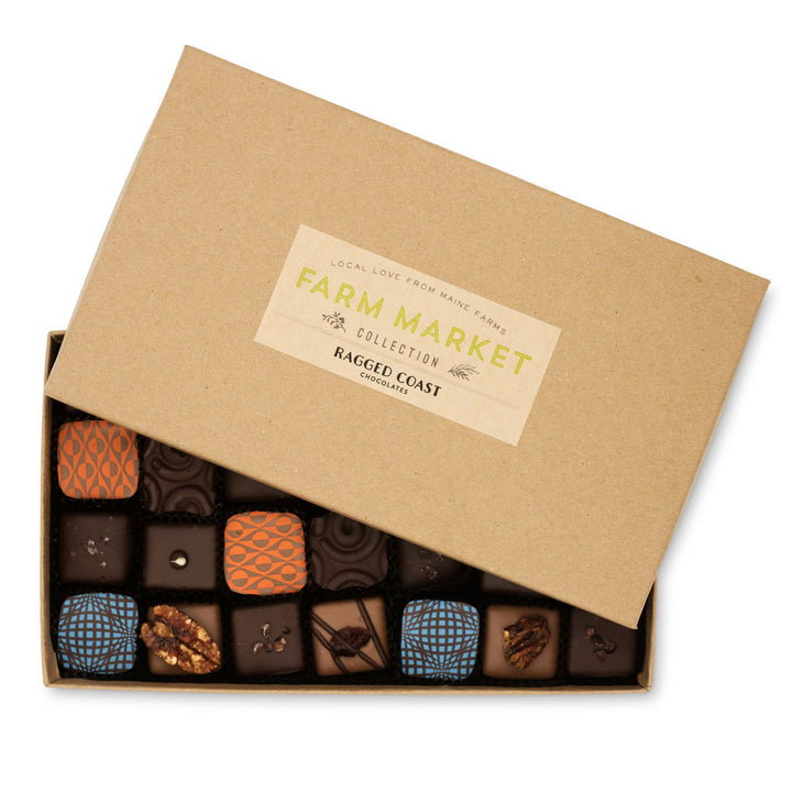Box of assorted artisan chocolates including dark chocolate sea salt caramels with a "Maine Farm Market Truffle Collection" label by Ragged Coast Chocolates.