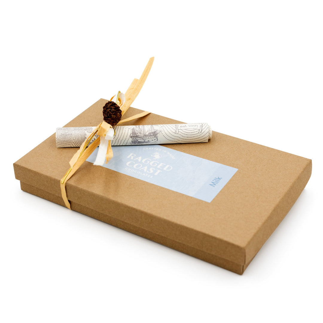 Brown Ragged Coast Chocolates gift box with a decorative grosgrain ribbon and a blue label on a white background.