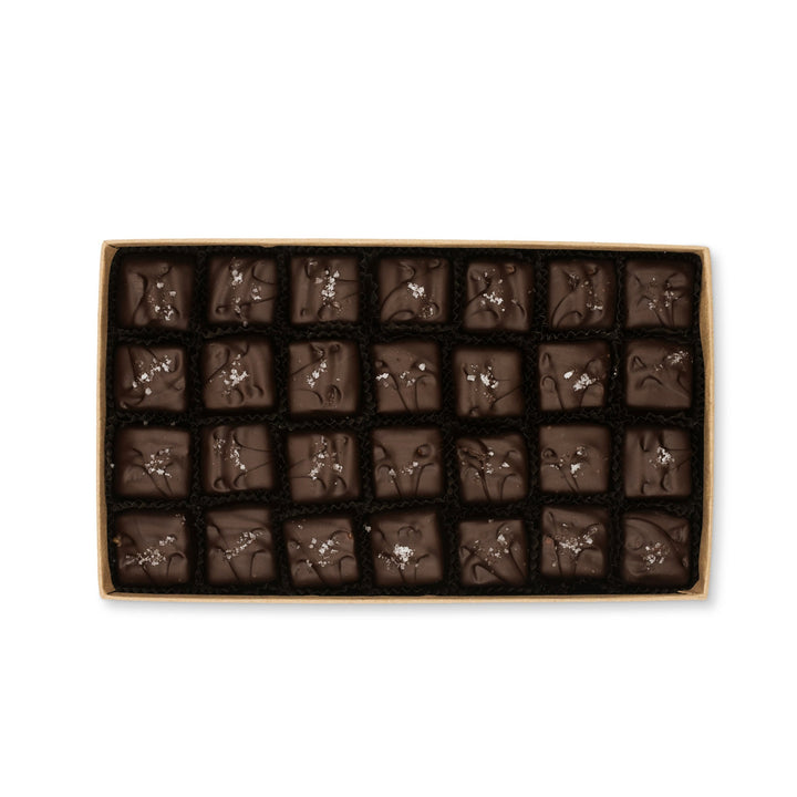 Box of assorted Ragged Coast Chocolates Sea Turtle Caramels on a white background.