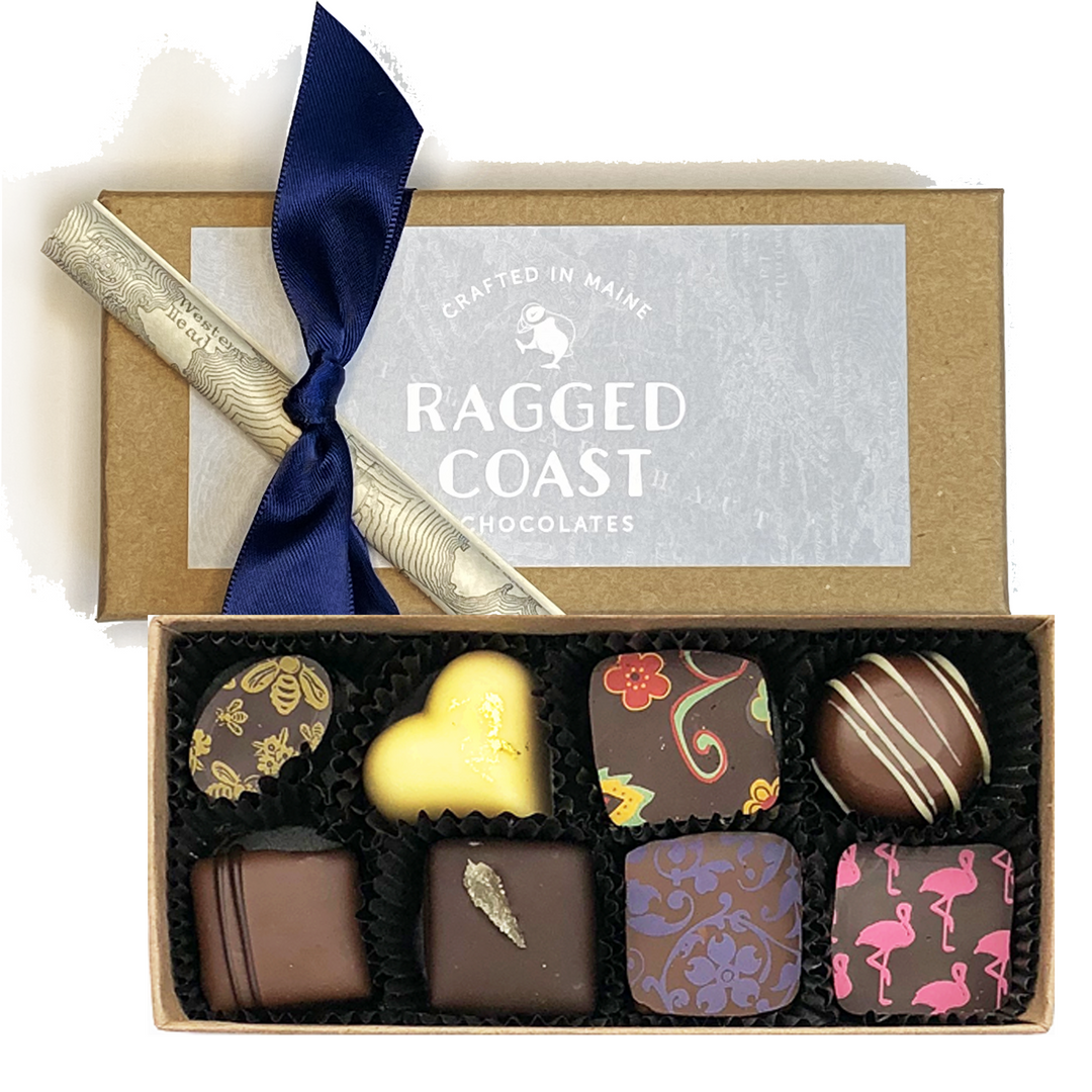 A box of Ragged Coast Chocolates eight-piece Chocolate Party Favor or Thank You Gift - Milk & Dark Chocolate Truffles with a decorative bow and a branded label on the lid.