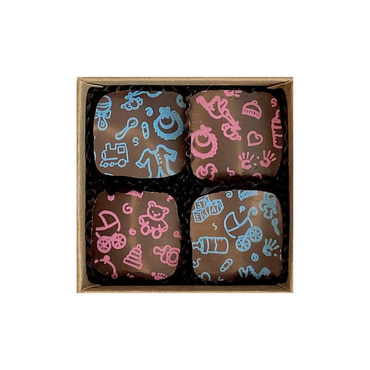 Four decorative cookies with patterned icing, perfect as Baby Shower or New Parent Chocolate Chocolate Gift favors, in a gift box from Ragged Coast Chocolates.