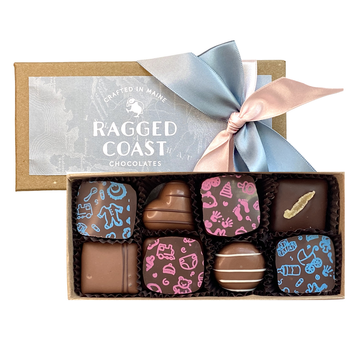 A box of Ragged Coast Chocolates' assorted chocolates with a decorative ribbon and branded packaging, perfect as Baby Shower or New Parent Chocolate Chocolate Gift favors.