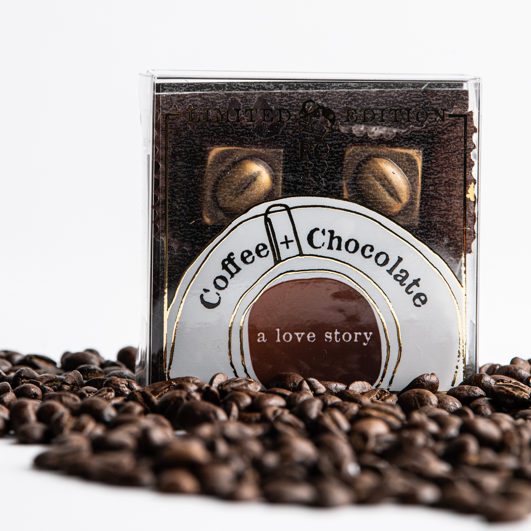 A cd case titled "coffee + chocolate a love story" surrounded by Ragged Coast Chocolates' Coffee + Chocolate Bourbon Barrel-Aged Coffee Caramels against a white background.