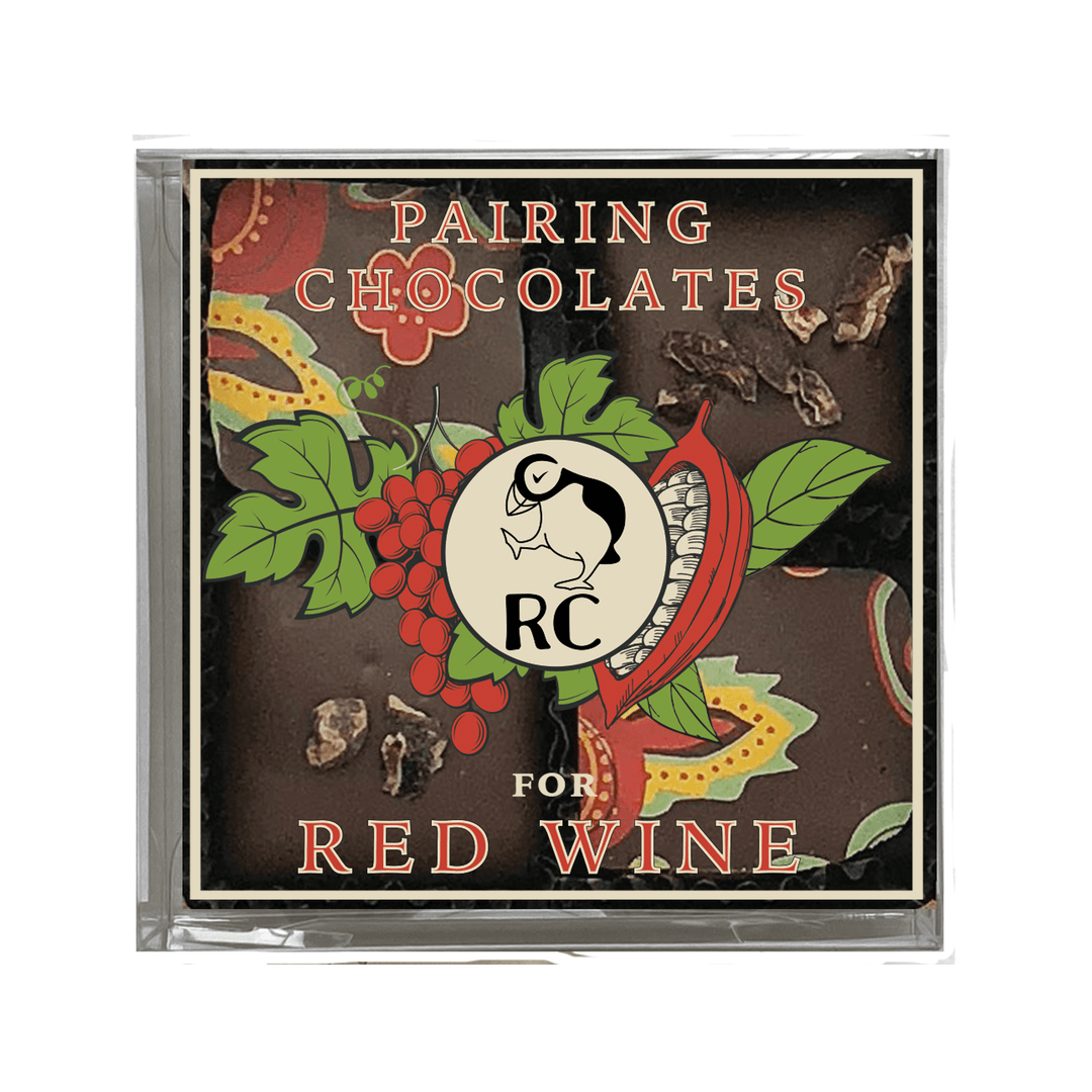 A book cover titled "Mother's Day Sampler Gift Box for Red Wine" with illustrations of grapes, chocolate pieces, and red chili peppers around a central emblem by Ragged Coast Chocolates.