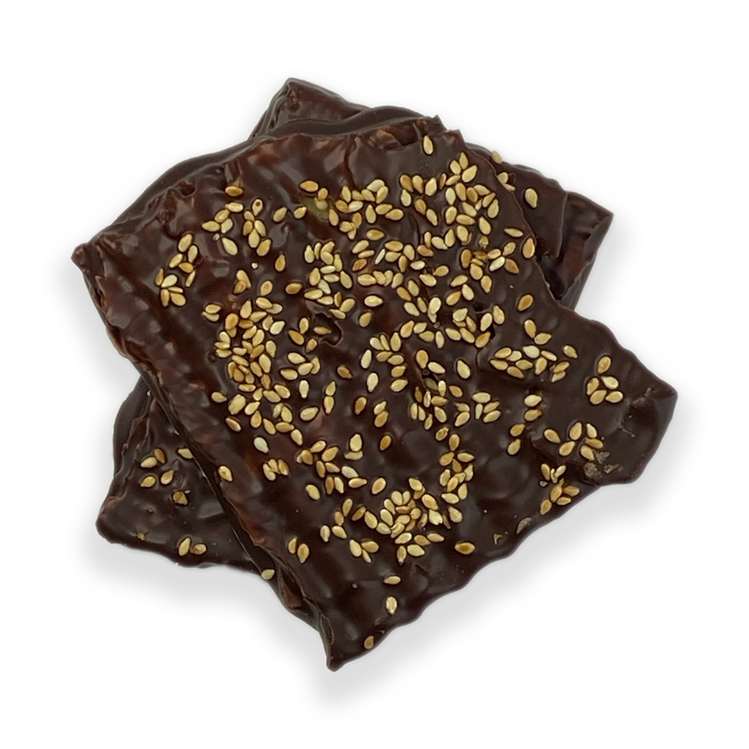Ragged Coast Chocolates Chocolate-Covered Toffee Matzos for Passover with sesame seeds and bittersweet chocolate on a white background.